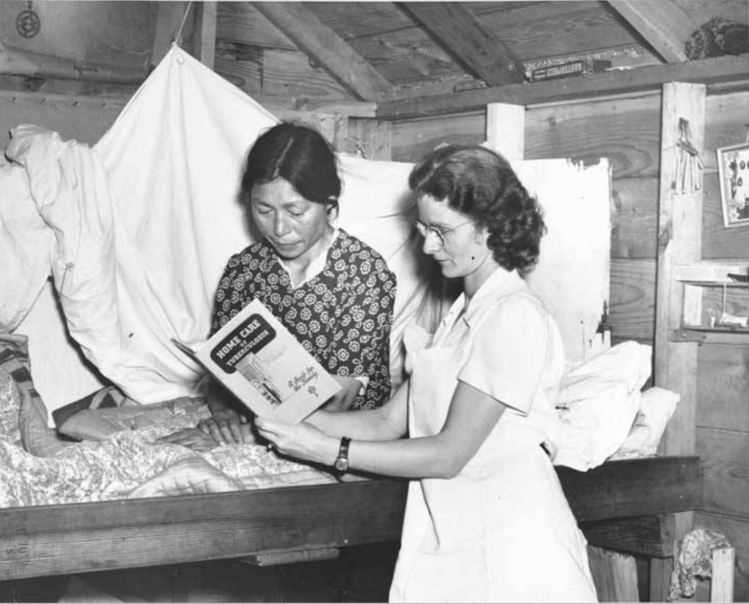 Public health travel nurse Morgan in Nome, Alaska with patient reviewing pamphlet titled “Home care of tuberculosis. A guide for the family.”