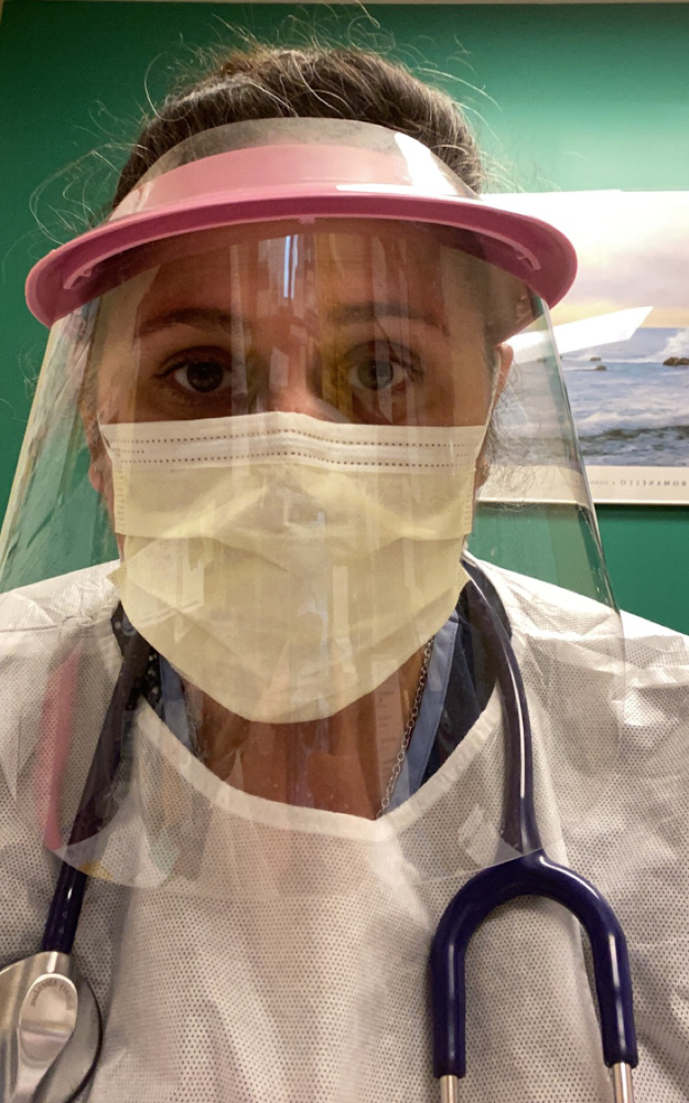 Brittney Ahrendsen in a face shield, mask, gown and stethoscope