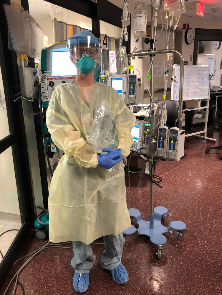Chelsea Cannon in gown, goggles and mask in a Covid ICU room