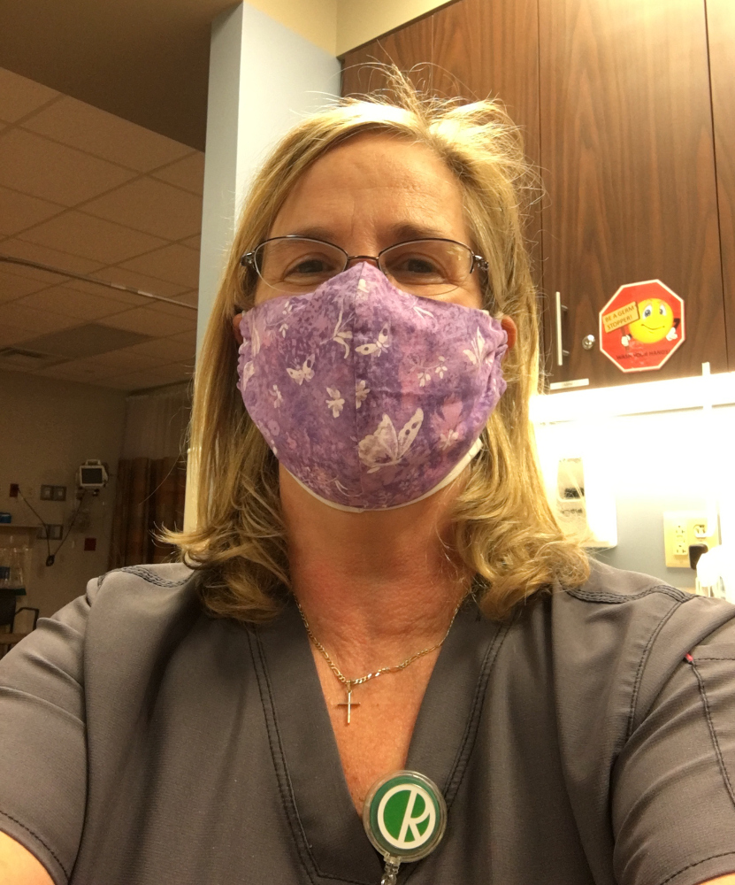 Crystal Clements in grey scrubs and a purple cloth mask on the unit