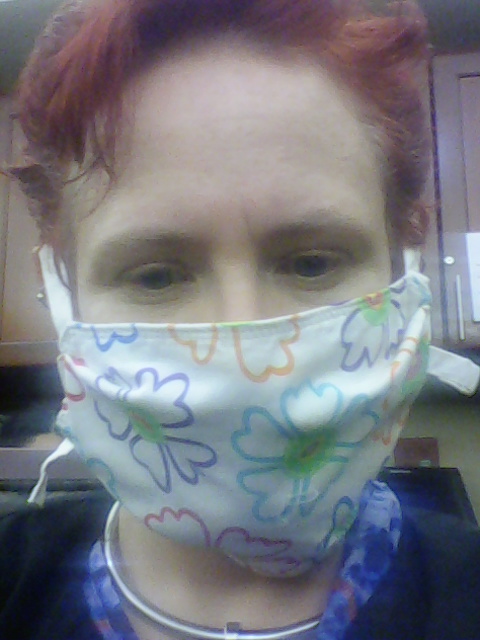 Close-up of Jennifer Wintermoon wearing a home-sewn floral cloth mask