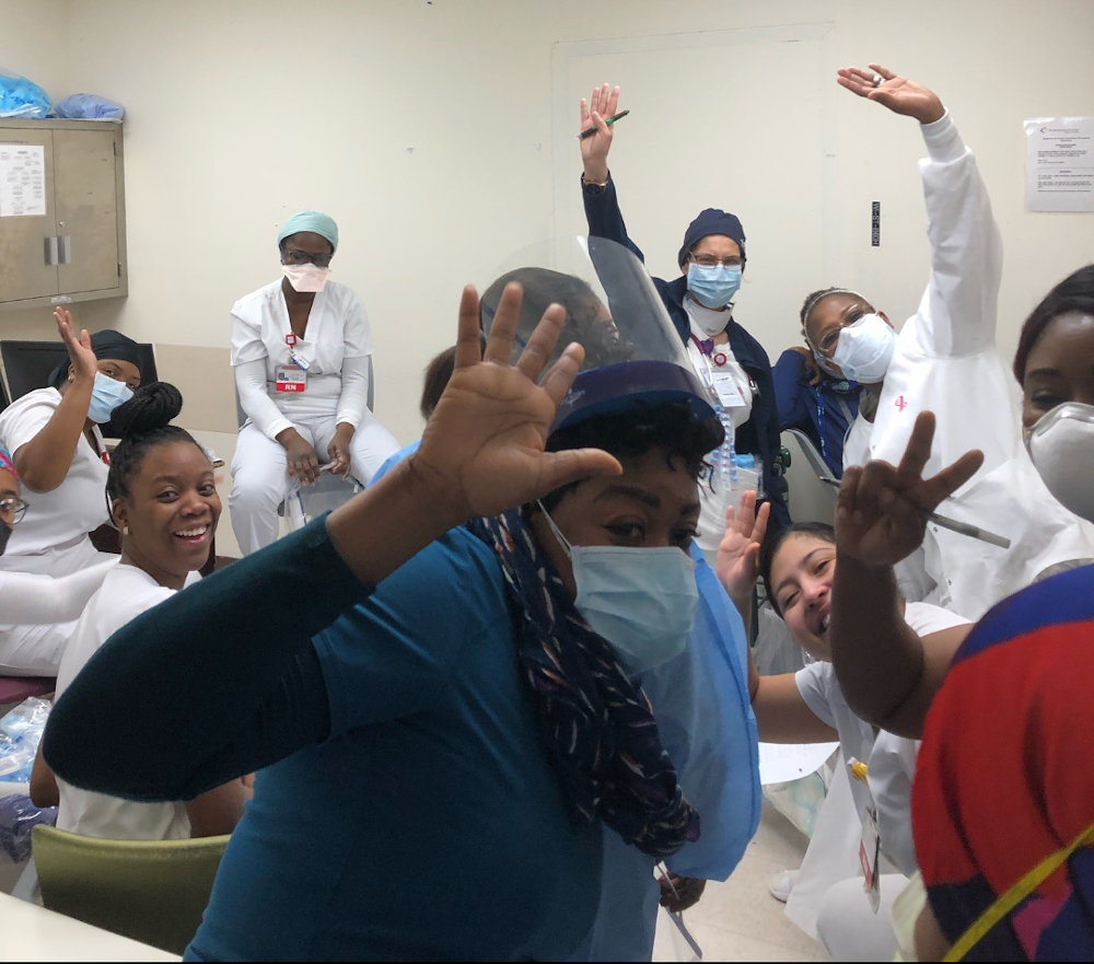 Brooklyn Hospital emergency room staff cheering with arms raised