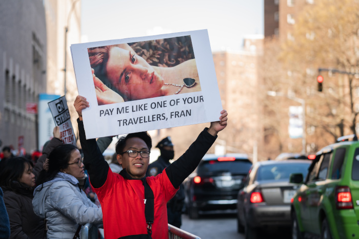 Picketing nurse holds a sign reading Pay me like one of your travellers, Fran